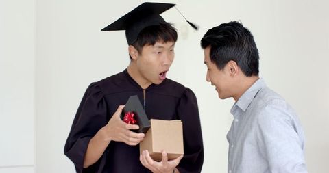 Proud Father Surprising Graduate Son with Gift at Home Celebration