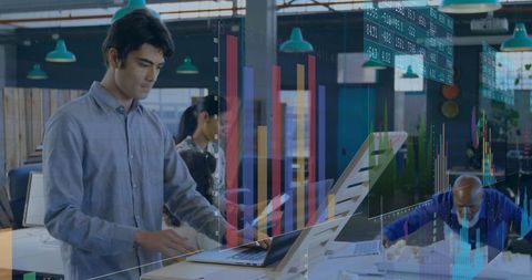 Business analyst working on laptop with digital charts overlaid