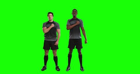 Confident Soccer Players Standing on Green Screen Background