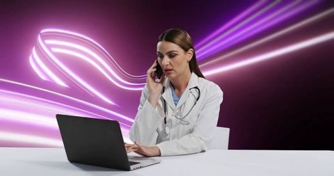 Doctor typing on laptop with futuristic neon lights background