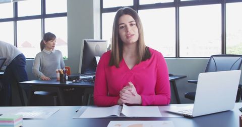 Professional woman having video call in modern office environment