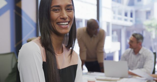 Smiling Businesswoman Working in Modern Office with Team - Download Free Stock Images Pikwizard.com