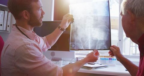Doctor Discussing X-ray with Senior Male at Retirement Home