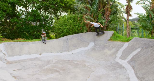 Two Skateboarders Riding Concrete Skate Bowl at Outdoor Skate Park - Download Free Stock Images Pikwizard.com