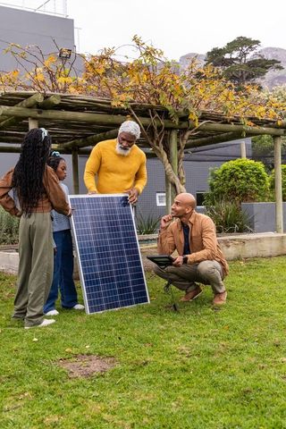 Multigenerational family installing solar panel under pergola in backyard learning renewables