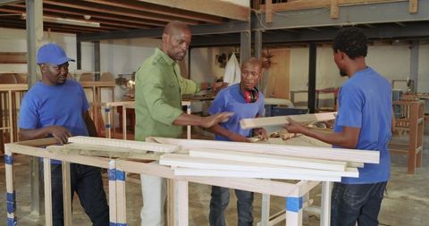 Collaborative woodworking project in industrial workshop