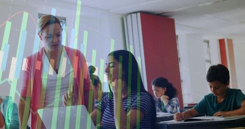 Teacher guiding student on laptop with interactive data overlays for collaborative classroom learnin