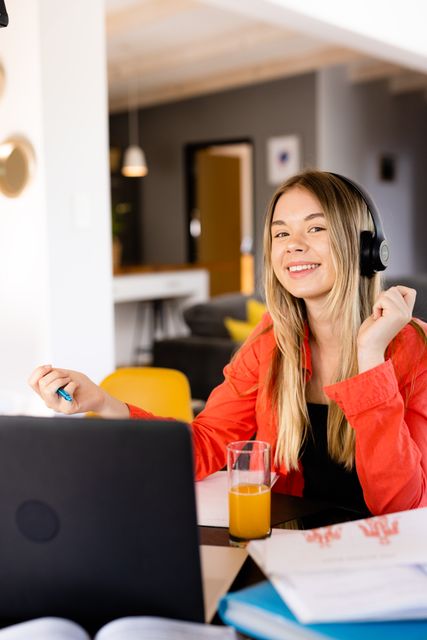 Teenage Girl Smiling with Headphones at Home Workspace - Download Free Stock Images Pikwizard.com