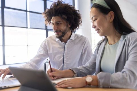 Diverse professional team collaborating with technology