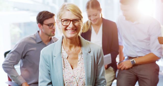 Smiling Mature Businesswoman Leading Team Meeting in Bright Office - Download Free Stock Images Pikwizard.com