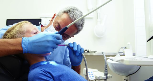 Dentist Treating Child Using Dental Equipment in Clinic - Download Free Stock Images Pikwizard.com