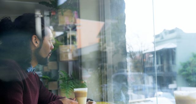 Man with Beard Looking Thoughtfully out of Cafe Window Sitting with Coffee - Download Free Stock Images Pikwizard.com