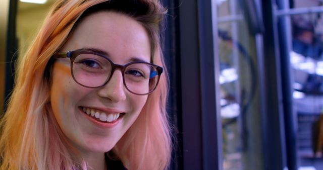 Smiling Young Woman with Glasses and Pink Hair Indoor Close-Up - Download Free Stock Images Pikwizard.com