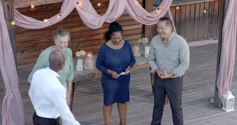 Senior Friends Laughing Together at Outdoor Garden Party