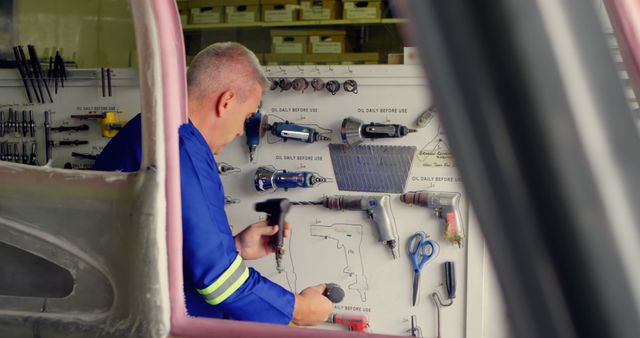 Mechanic in Blue Uniform Working with Tools in Garage - Download Free Stock Images Pikwizard.com