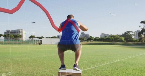 Explosive box jump with digital performance overlay by male athlete training outdoors