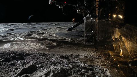 Lunar lander leg reflecting gold foil on regolith with distant earth on horizon