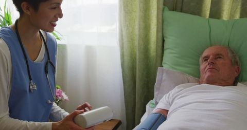 Doctor Checks Vital Signs of Senior Man in Nursing Home