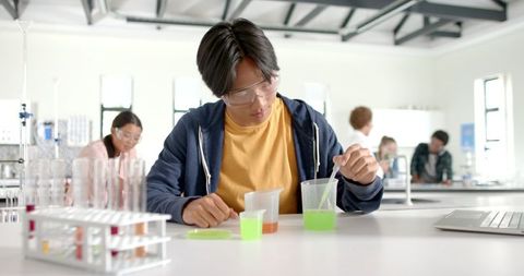 Teen Scientist Conducting Chemistry Experiment in School Lab