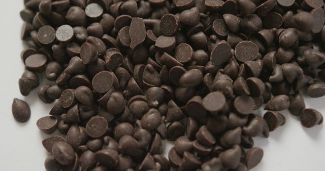 Pile of Dark Chocolate Chips on White Background - Download Free Stock Images Pikwizard.com