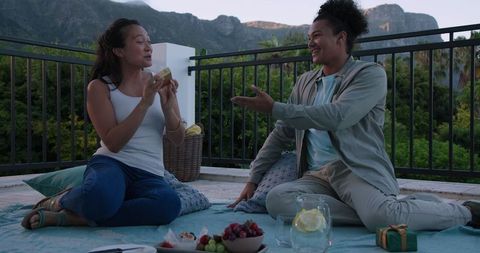 Couple Relaxing Outdoors with Mountain Scenic View