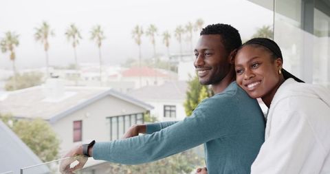 Affectionate Couple Enjoying Scenic Urban Balcony View