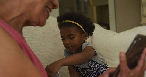 Grandmother and Granddaughter Bonding with Tablet Technology