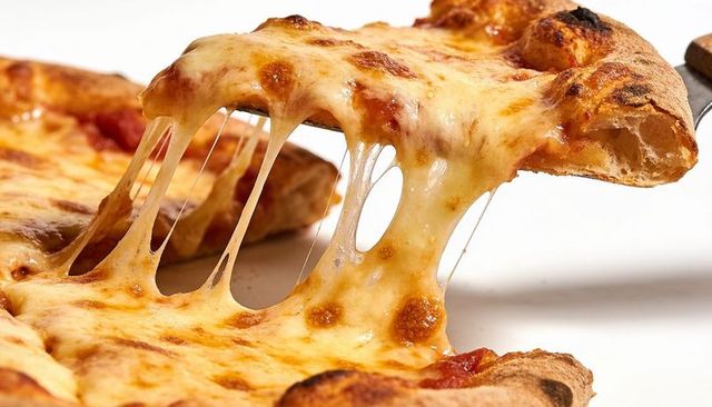 Stretching mozzarella pull on gooey cheese pizza slice with golden charred crust