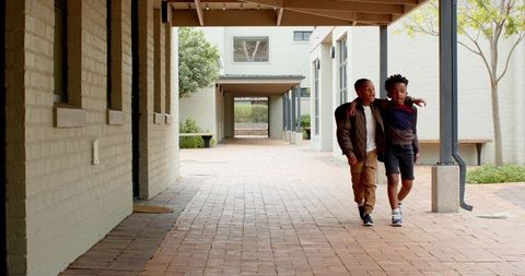 Diverse Child Friends Walking Together in Urban School Courtyard