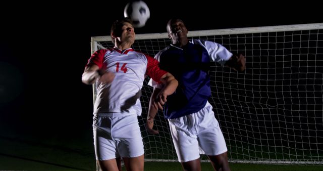 Soccer Players Competing for Ball during Night Match - Download Free Stock Images Pikwizard.com