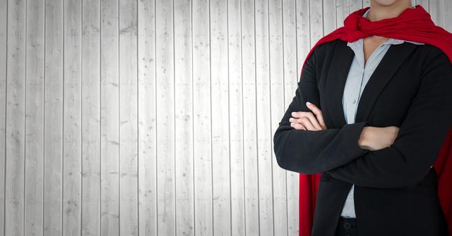 Confident Businesswoman In Superhero Cape Against Grey Wooden Wall - Download Free Stock Photos Pikwizard.com