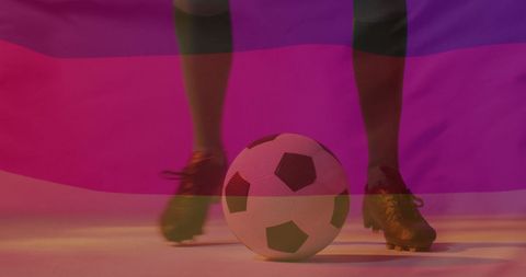 Caucasian male soccer player with ball and flag overlay