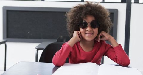 Smiling African American Child Wearing Sunglasses in Classroom