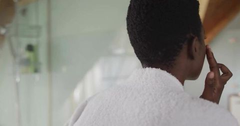Morning Skincare Routine with Afro Hair Woman in Cozy Bathroom