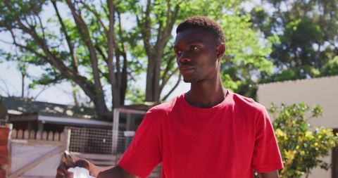 Volunteer tending dogs at outdoor animal shelter