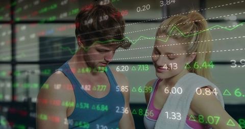 Young couple checking fitness analytics with financial market data overlay in gym
