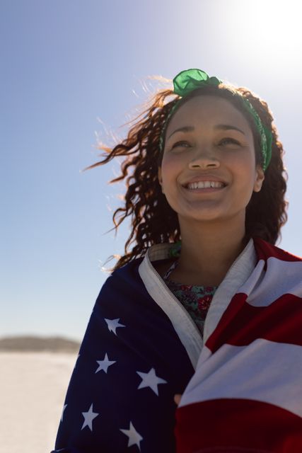 Biracial colleague wearing American flag, standing outdoors. She has curly brown hair, light brown skin, and is wearing green headband, unaltered