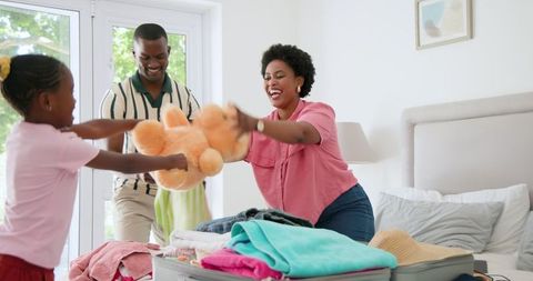 Joyful Family Packing for Trip Together