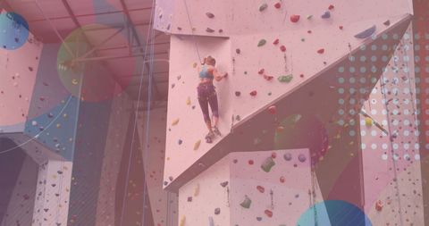 Caucasian woman rock climbing on indoor gym wall with abstract overlay