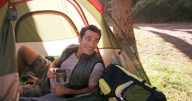 Happy Camper Relaxing in Tent with Mug in Hand - Download Free Stock Images Pikwizard.com