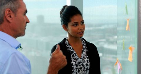 Business professionals engaged in strategy discussion with growth charts