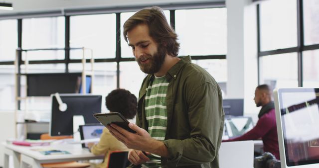 Casual Office Worker Using Digital Tablet in Modern Open Space - Download Free Stock Images Pikwizard.com