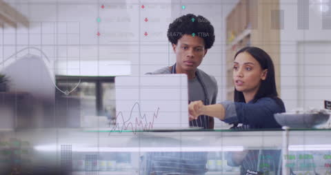 Diverse Cafe Team Analyzing Financial Data on Laptop