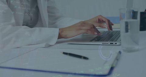 Woman Analyzing Data on Laptop in Modern Office Environment