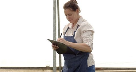 Woman Conducting Research in Greenhouse Environment
