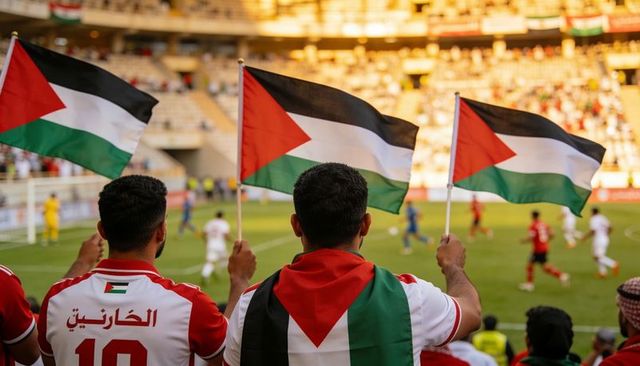 Palestinian fans waving flags at football match during golden hour celebration