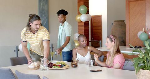 Diverse Group of Friends Enjoying Snacks at Festive Gathering