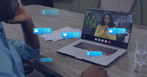 Remote team video meeting on laptop with live reaction overlays, virtual collaboration