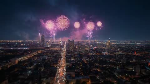 Vibrant Cityscape with Spectacular Fireworks Display at Night