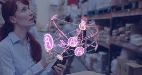 Warehouse manager using tablet with holographic network visualizing inventory and logistics